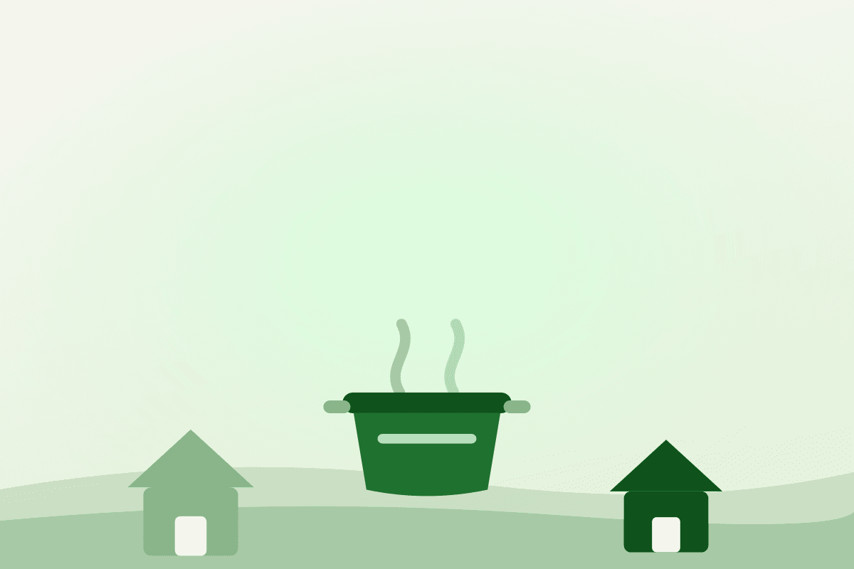 Flat illustration of a large cooking pot set between two small houses, representing shared community kitchens